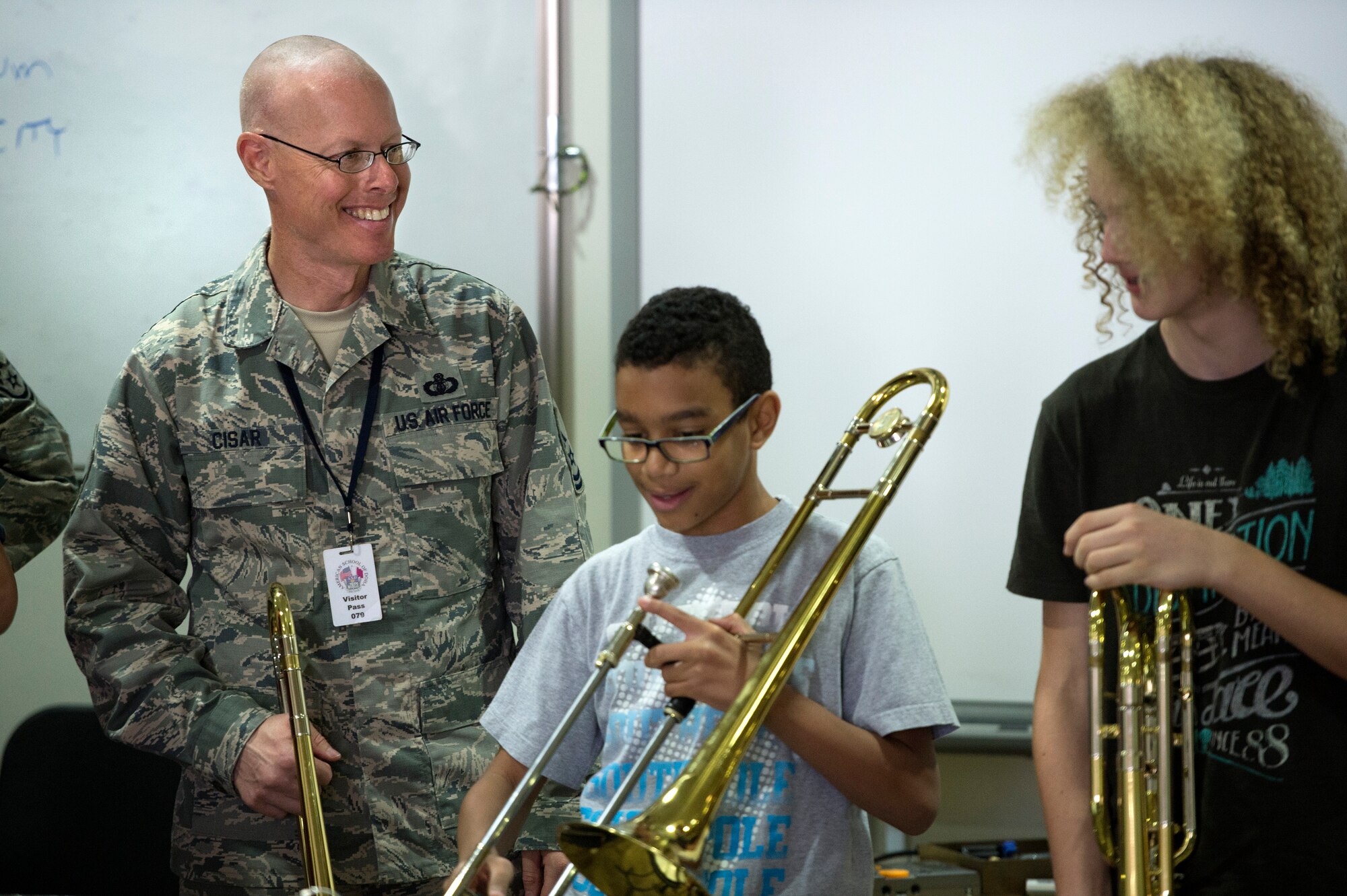Master Sgt. John Cisar, AFCENT Band trombone player, shares a laugh with high school band students at the American School of Doha May 30, 2013. Cisar, along with two other brass instrumentalists, conducted a masters class with students in their final weeks of school.  ASD is attended by students from more than 80 nations. (USAF Photo by Master Sgt. Ben Bloker)