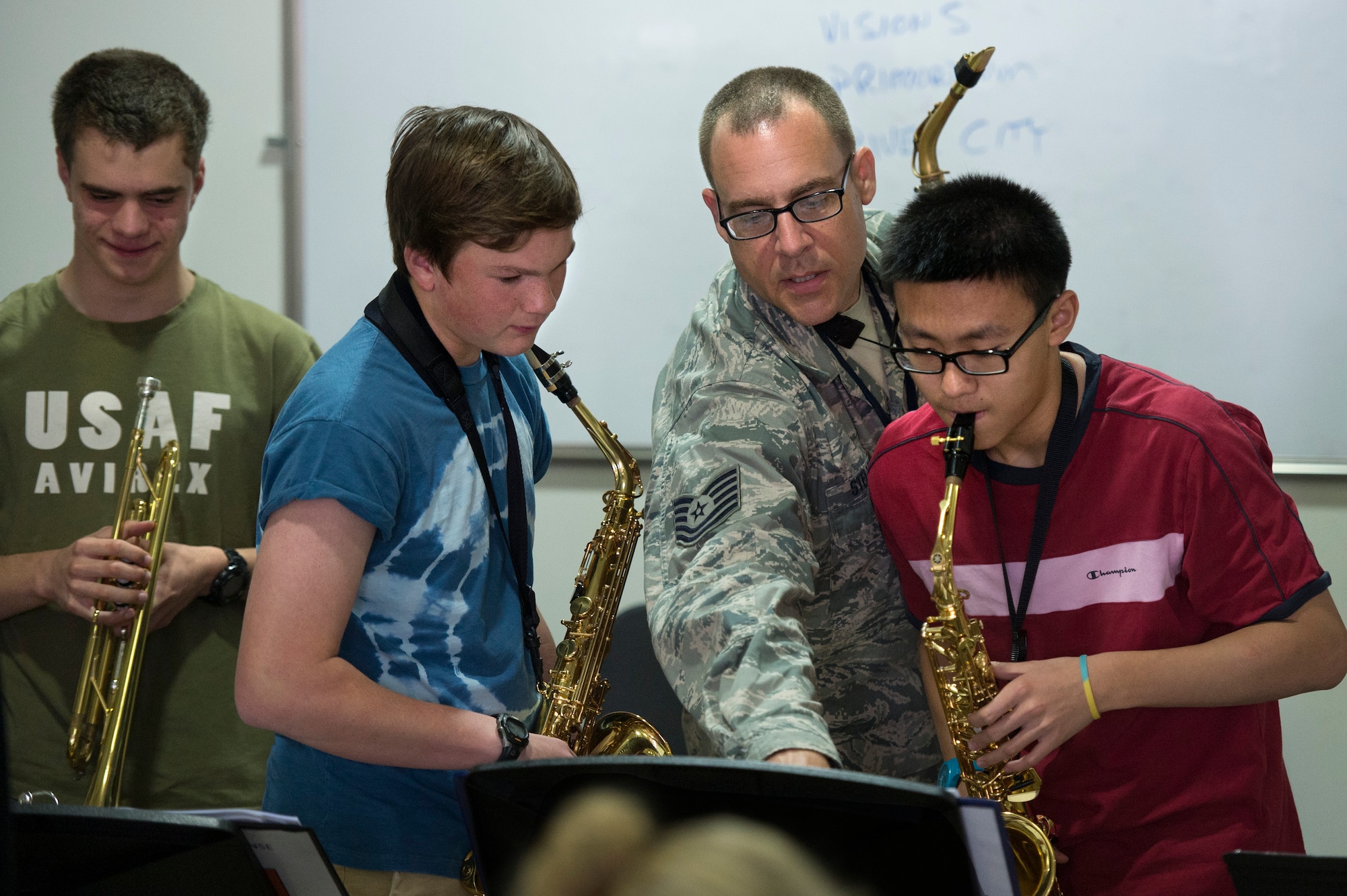 Tech Sgt. Chris Stelling, AFCENT Band saxophone player, mentors high school band students at the American School of Doha May 30, 2013. Stelling, along with two other brass instrumentalists, conducted a masters class with students in their final weeks of school.  ASD is attended by students from more than 80 nations. (USAF Photo by Master Sgt. Ben Bloker)