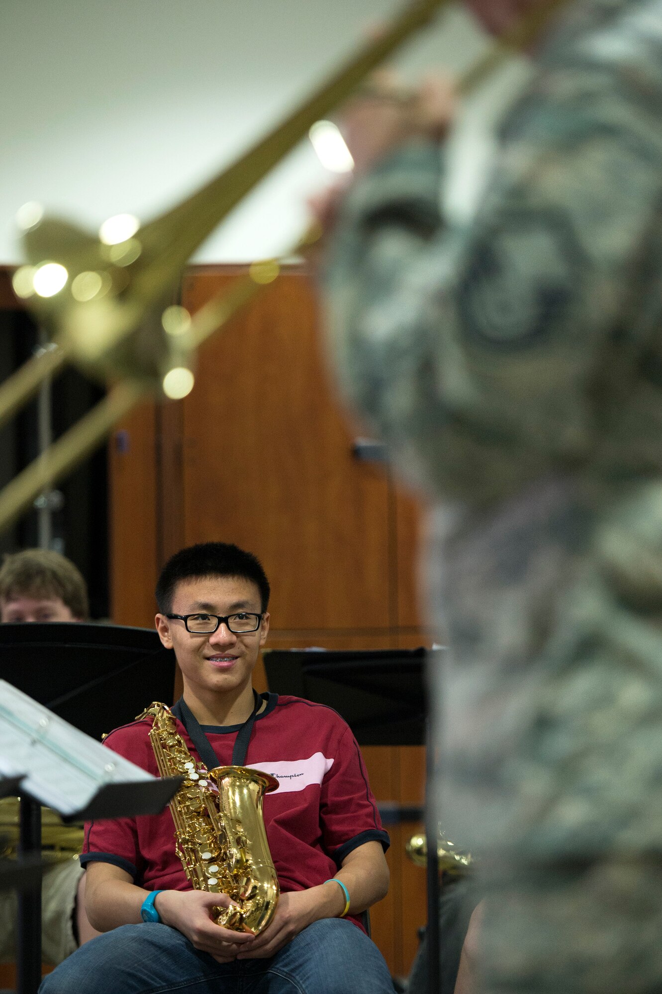 A student from the American School of Doha takes in a performance by Master Sgt. John Cisar, AFCENT Band trombone player, May 30, 2013. Cisar, along with two other brass instrumentalists, conducted a masters class with students in their final weeks of school.  ASD is attended by students from more than 80 nations. (USAF Photo by Master Sgt. Ben Bloker)

