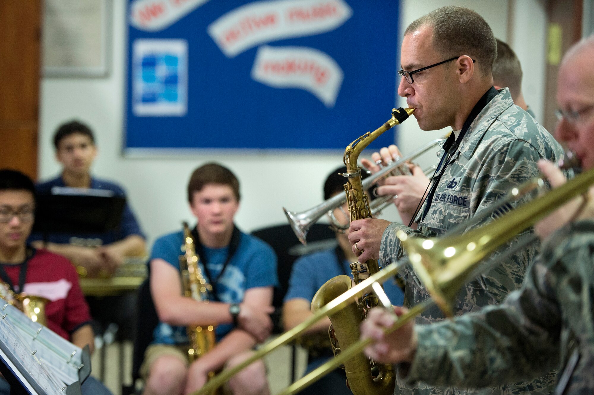 Tech Sgt. Chris Stelling, AFCENT Band saxophone player, entertains high school band students at the American School of Doha May 30, 2013. Stelling, along with two other brass instrumentalists, conducted a masters class with students in their final weeks of school.  ASD is attended by students from more than 80 nations. (USAF Photo by Master Sgt. Ben Bloker)

