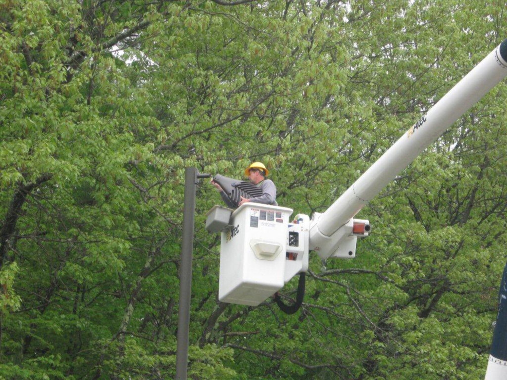 A contractor installs a new light emitting diode street fixture at New
Boston Air Force Station, N.H. It is one of 15 Air Force Space Command
installations to receive the energy-saving lights. AFSPC centrally purchased
6,600 lights which will save $975,000 annually on reduced operations and
maintenance costs. (U.S. Air Force photo)

