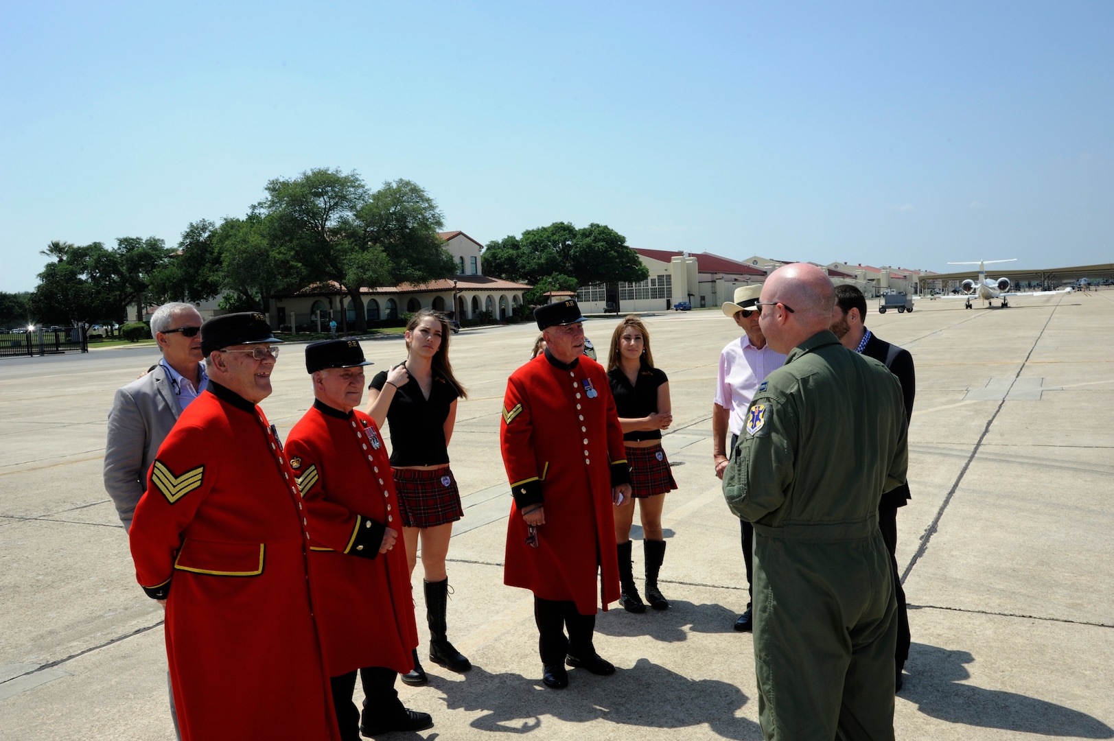 Cody Goetz (right), 560th Flying Training Squadron instructor pilot, gives Chelsea Pensioner ( from left to right) Donald crassweller, William Fox and David Thomson a guided tour of the 560th FTS May 16 at Joint Base - San Antonio-Randolph.  ( U.S. Air Force photo by Don Lindsey / Released)