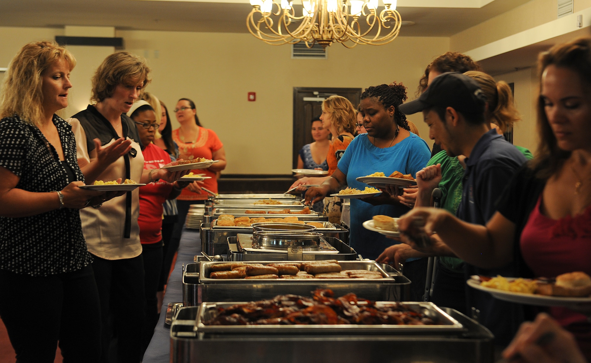 Unit key spouses grab breakfast at the Officer's Club on Kadena Air Base, Japan, May 31, 2013. The Airmen and family readiness center held the breakfast to show appreciation to Kadena key spouses and recognize their role of ensuring their husbands and wives are mission ready. (U.S. Air Force photo by Airman 1st Class Malia Jenkins/Released)