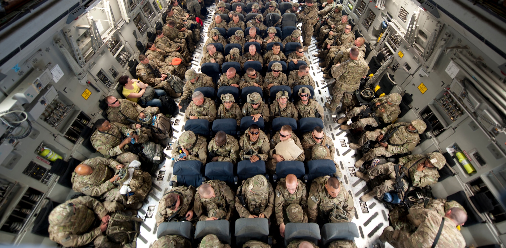 Air Force and Army service members secure seats on a C-17 Globemaster III as they prepare to depart Transit Center at Manas, Kyrgyzstan, May 27, 2013. The troops and gear were processed onto the C-17 by the 376th Expeditionary Logistics Readiness Squadron Air Terminal Operations Center. ATOC moves approximately 1,200 passengers a day. (U.S. Air Force photo /Staff Sgt. Robert Barnett)