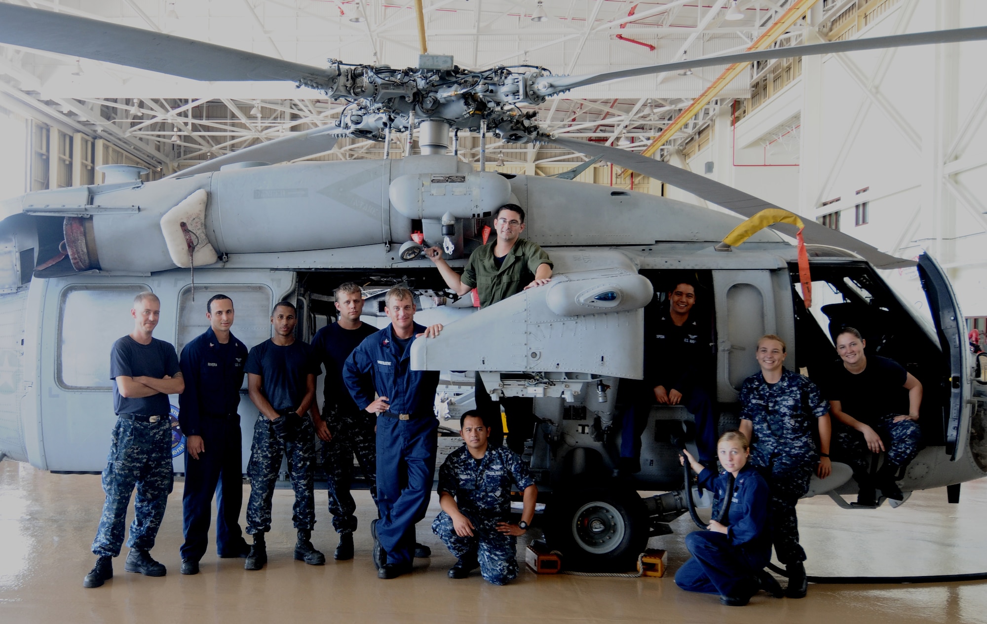 A group of Helicopter Sea Combat Squadron 25 maintainers pose for a photo May 30, 2013, on Andersen Air Force Base, Guam. Currently, HSC-25 has two maintenance shifts to provide around-the-clock support for search and rescue missions, firefighting and medical evacuations along with a multitude of other military operations. (U.S. Air Force photo by Airman 1st Class Mariah Haddenham/Released)