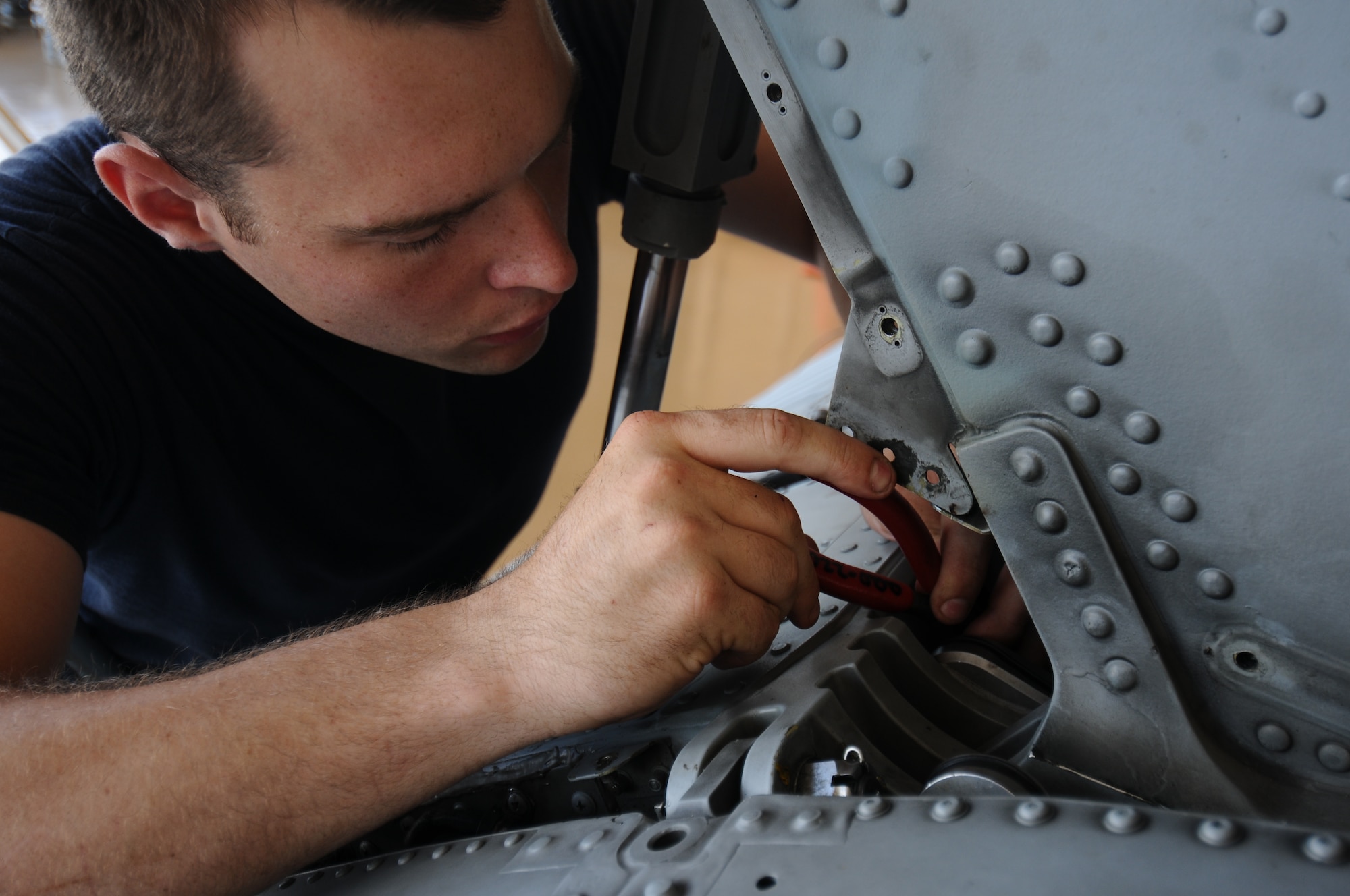 U.S. Navy Petty Officer 3rd Class John Evans, Helicopter Sea Combat Squadron 25 aviation electrician’s mate, puts together a position sensor May 30, 2013, on Andersen Air Force Base, Guam. This particular position sensor tells the pilot what angle the tail is at regardless of whether the helicopter is in the air or on the ground. (U.S. Air Force photo by Airman 1st Class Emily A. Bradley/Released)