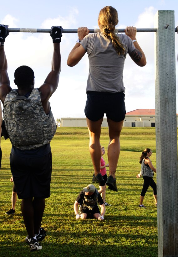 Participants work to complete pull-ups at the Memorial Day CrossFit “Murph” May 23, 2013, on Andersen Air Force Base, Guam. The workout consisted of a one-mile run, 100 pull- ups, 200 pushups, 300 squats, then another one-mile run to pay homage to service members who made the ultimate sacrifice in the line of duty. (U.S. Air Force photo by Airman 1st Class Mariah Haddenham/Released)