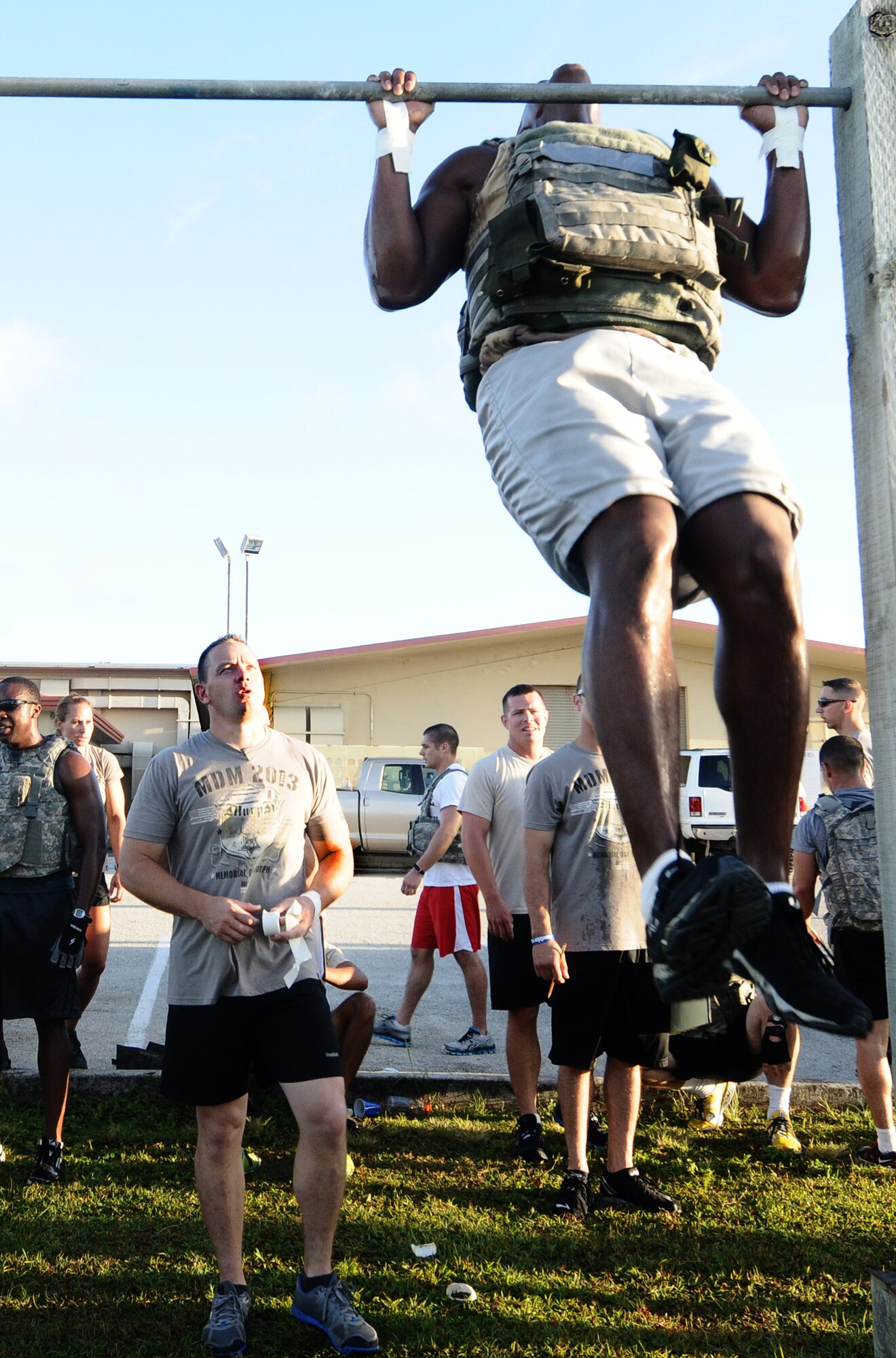 1st Lt. Brian Slater, 36th Security Forces Squadron assistant operations officer, supervises a participant during a CrossFit workout May 23, 2013, on Andersen Air Force Base, Guam.  Slater’s personal experiences with CrossFit inspired him to help start a group at Andersen. (U.S. Air Force photo by Airman 1st Class Mariah Haddenham/Released)
