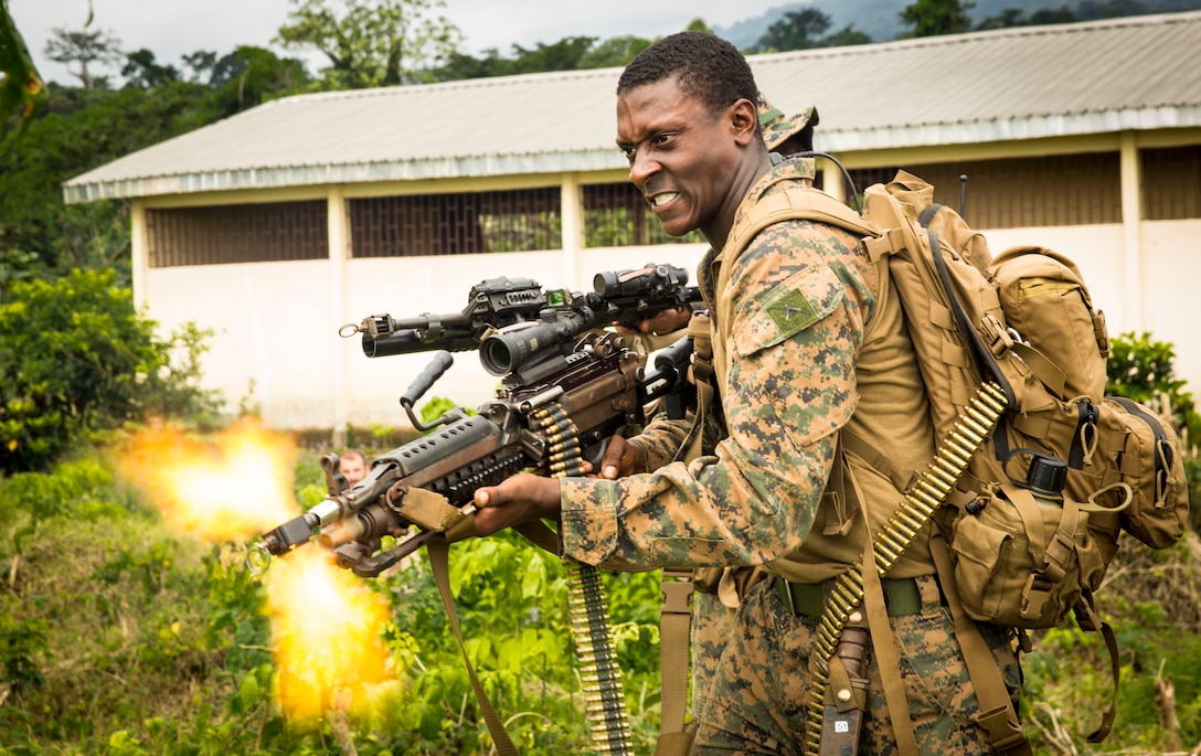 Roleplaying as the opposition force, Lance Cpl. Nickolas Garrett of Monroe, Ga., fires blank rounds at enemy forces during a simulated amphibious beach landing October 25, 2013.  The successful event proved the APS 13 Marines and sailors truly made a difference in the operational efficiency of the African military force. Africa Partnership Station is conducted with the concept that bilateral training with African partners can create effective maritime security and safety that will contribute to the development, economic prosperity and security ashore within Africa.  