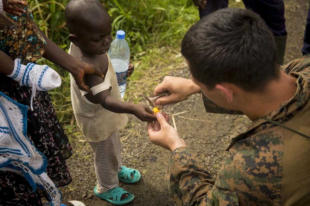 Lance Cpl. Nathan Green of St. Cloud, Fla. Shares his rations with locals after a beach assault October 25, 2013. The last engagement, set in Cameroon, allowed the U.S. Marines and sailors of APS 13 ample time to focus on the basics of combat medicine, assorted combat techniques and tactics, martial arts and more.  Still, the most important thing the Marines and sailors built was relationships with the local populace. Africa Partnership Station is conducted with the concept that bilateral training with African partners can create effective maritime security and safety that will contribute to the development, economic prosperity and security ashore within Africa. 