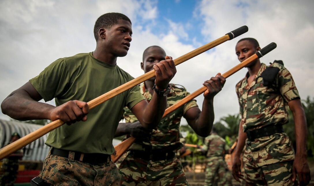 Corporal Stephen Fisher (left), a Marine Corps Martial Arts Program instructor with the unit, took the lead with the “One Mind, Any Weapon,” program, and focused on basic moves such as lead and rear hand punches, knee strikes, arm manipulations and more October 25, 2013. The Hurt, Va., native, made sure to stress to the Cameroon Marines what the program is all about: physical, mental and character discipline.  Africa Partnership Station is conducted with the concept that bilateral training with African partners can create effective maritime security and safety that will contribute to the development, economic prosperity and security ashore within Africa.