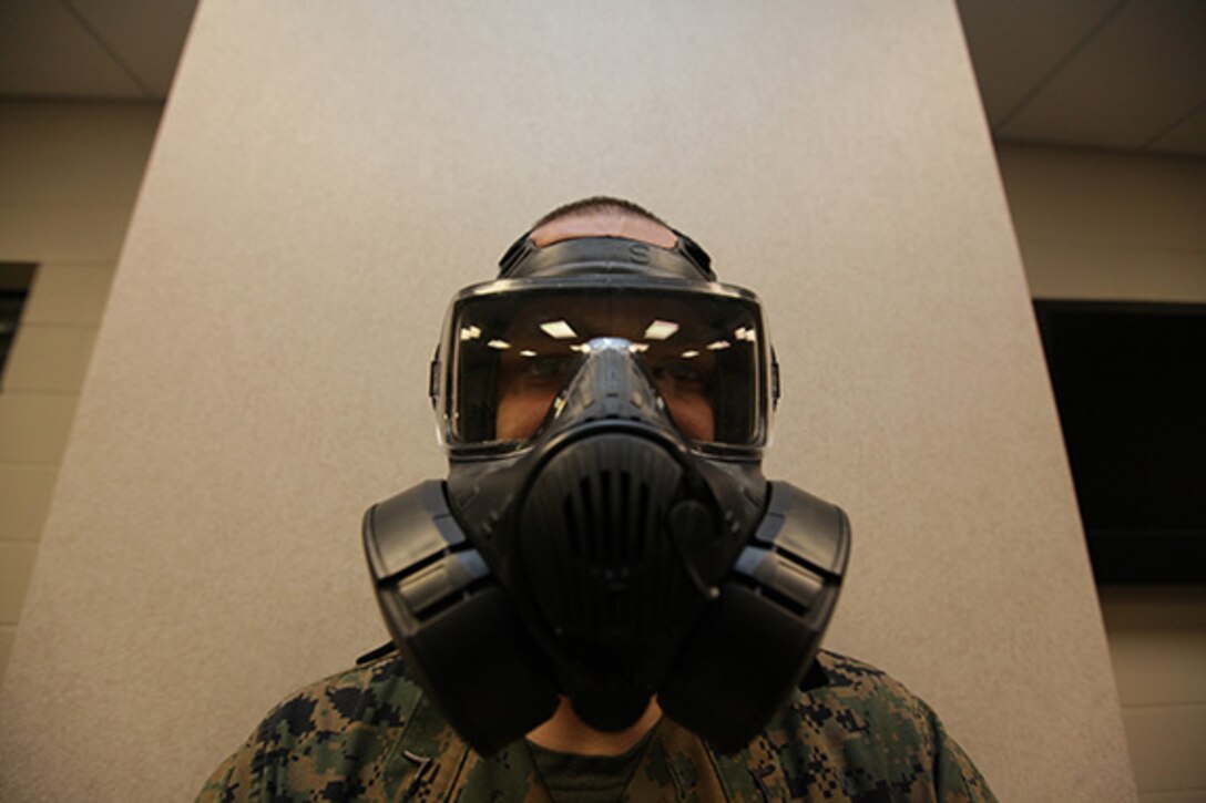 Private First Class Justin Morris, Marine Aviation Logistics Squadron 31 nuclear, biological and chemical defense specialist, wears the new Joint Service General Purpose Mask aboard the Air Station, Jan. 13. Headquarters and Headquarters Squadron Marines are now issued the new masks to keep Marines current on sustainment training.