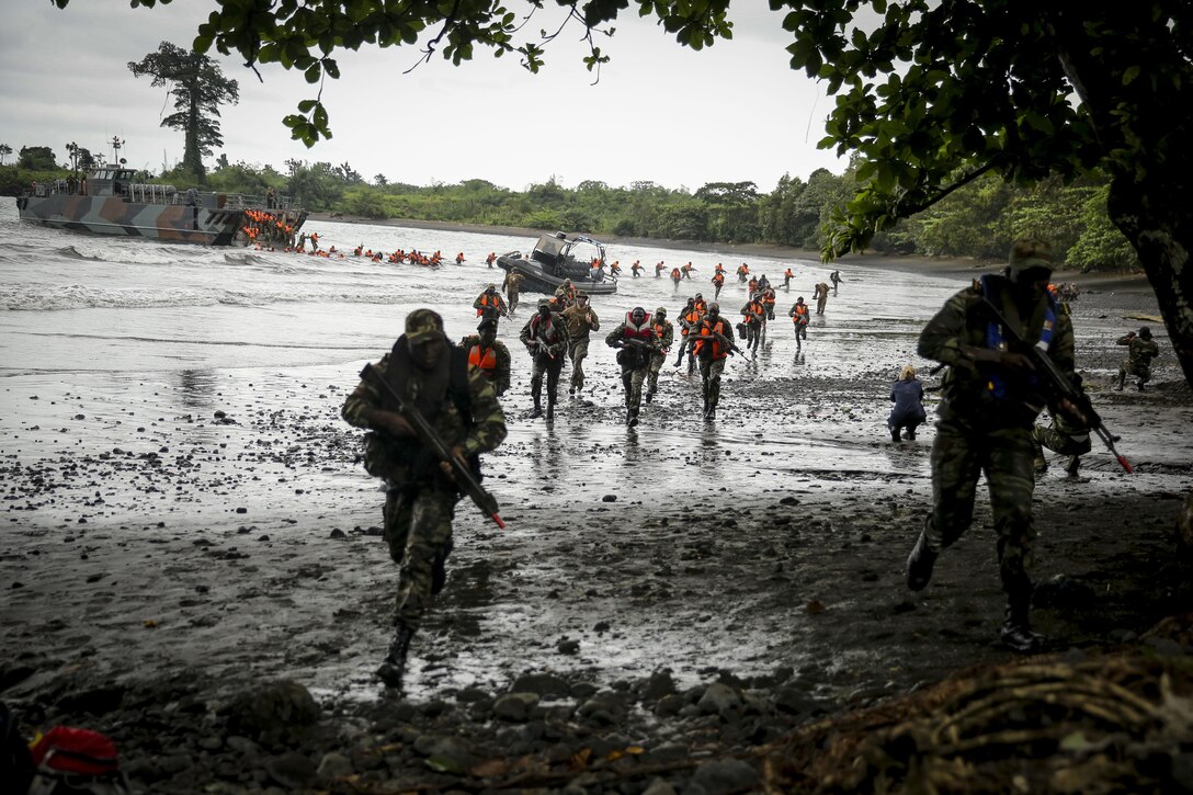 Cameroon Marines storm the shores during a simulated amphibious beach landing in which U.S., Spanish and Cameroon Marines assaulted a beach where role-playing enemy forces awaited their arrival.  The air filled with the sights of muzzle flashes, smoke and dozens of International military forces emerging from the shores.  Africa Partnership Station is conducted with the concept that bilateral training with African partners can create effective maritime security and safety that will contribute to the development, economic prosperity and security ashore within Africa. 