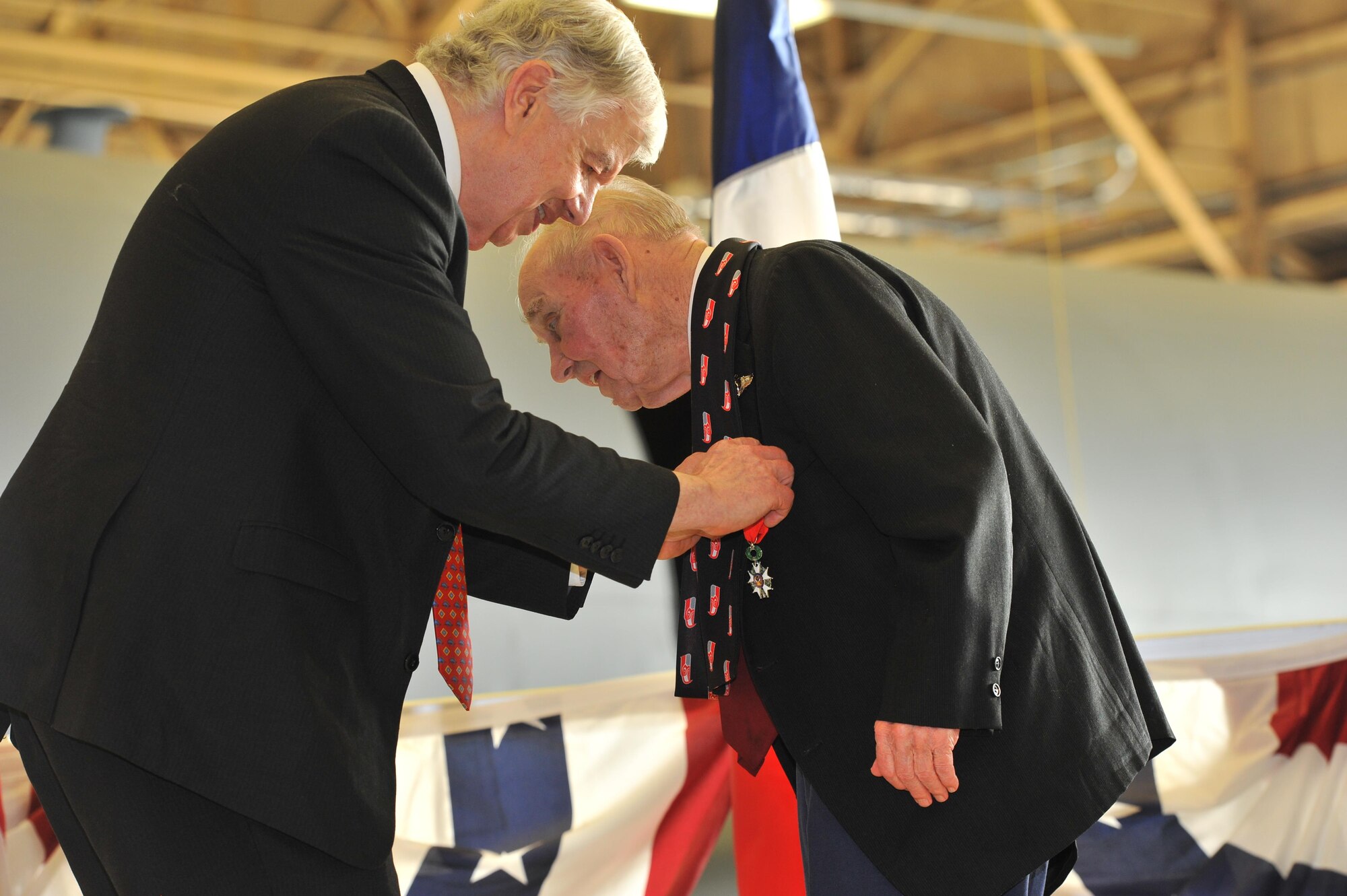 Jack Cowan of the Honorary Consul of France, presents the French Legion of Honor Medal to retired Maj. Clarence Grimes Oct. 25, 2013, at Fairchild Air Force Base, Wash. The 92-year old was honored with the highest recognition by the French government for his contributions almost 70 years ago to defend and preserve the independence of France. 