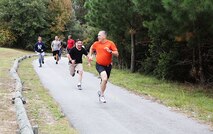 Navy Capt. Michael Sokolowski (front), the commanding officer of 2nd Medical Battalion, Combat Logistics regiment 25, 2nd Marine Logistics Group runs from a service member playing the role as a ‘zombie’ during a zombie run held by the battalion aboard Camp Lejeune, N.C., Oct. 31, 2013. The run was a way for the battalion to have fun while conducting physical training. (U.S. Marine Corps photo by Lance Cpl. Shawn Valosin)