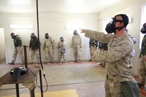 Lance Cpl. Thomas W. Edgemon, a chemical, biological, radiological and nuclear defense specialist with Combat Logistics Regiment 27, 2nd Marine Logistics Group directs service members with 2nd Supply Battalion, Combat Logistics Regiment 25, 2nd MLG to leave the gas chamber after completing a mask confidence exercies aboard Camp Lejeune, N.C., Oct. 31, 2013. Marines and sailors with 2nd Supply Bn. endured the gas chamber to maintain mission readiness in the event of chemical, biological, radiological and nuclear attacks.