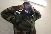 Pvt. Sean D. Gagnon, an automotive organizational mechanic with 2nd Supply Battalion, Combat Logistics Regiment, 2nd Marine Logistics Group breaks the seal of his M50 Joint Service General Purpose Mask during a mask confidence exercise aboard Camp Lejeune, N.C., Oct. 31, 2013. Marines and sailors with the unit received individual survival measures classes and conducted mask confidence exercise, which are annual requirements for Marines and sailors to maintain mission readiness.