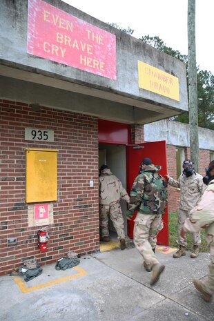 Marines and sailors with 2nd Supply Battalion, Combat Logistics Regiment, 2nd Marine Logistics Group enter a gas chamber during a mask confidence exercise aboard Camp Lejeune, N.C., Oct. 31, 2013. The service members performed several tests inside the gas chamber to make sure their protective masks have tight seals and won’t leak chemical, biological, radiological and nuclear agents onto their faces.