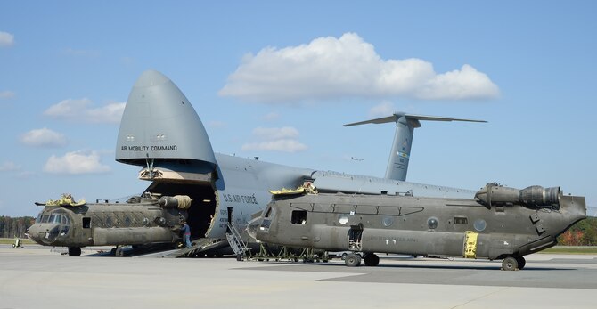 Army CH-47D Chinook helicopters and their components are unloaded from a C-5M Super Galaxy Oct. 29, 2013, at Dover Air Force Base, Del. The helicopters were used in Afghanistan and are being returned to the United States as military forces are withdrawn from the country. The C-5s are assigned to the 436th Airlift Wing. 