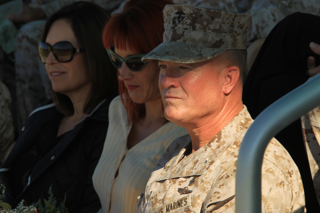 Col. George C. Aucoin sits with his wife and sister during his retirement ceremony held at Lance Cpl. Torrey L. Gray Field, Oct. 31, 2013.