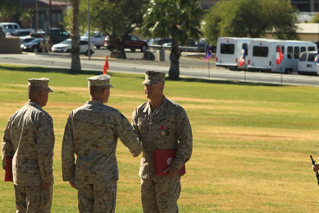 Col. George C. Aucoin shakes hands with Lt. Gen. Jon M. Davis, deputy commander, United States Cyber Command, during his retirement ceremony held at Lance Cpl. Torrey L. Gray Field, Oct. 31, 2013.