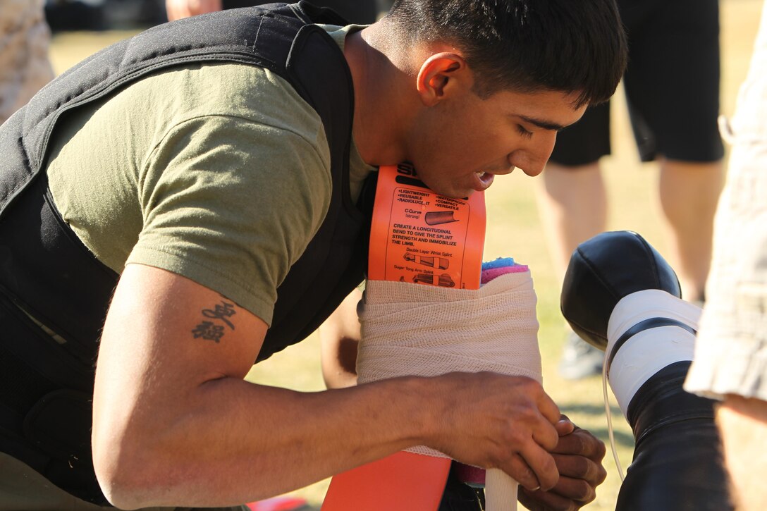 Cpl. Jorge Vega, squad leader, 2nd Battalion, 7th Marine Regiment, provides medical care for a simulated casualty as part of the last competition of the Combat Center Challenge, Oct. 25.