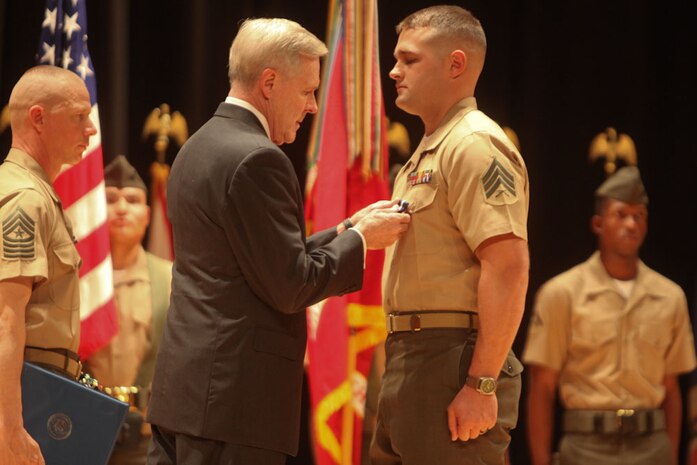 MARINE CORPS BASE CAMP LEJEUNE, N.C. – Sergeant Joshua L. Moore is presented the Navy Cross from the Secretary of the Navy, the Honorable Ray Mabus, during an awards ceremony aboard Camp Lejeune, N.C., Nov. 1, 2013.  Moore, 25, from Franklinville, N.C., received the military’s second highest award for his extraordinary heroism while serving as a scout with scout sniper platoon, 2nd Battalion, 8th Marine Regiment, Regimental Combat Team 1, 2nd Marine Division Forward, 2nd Marine Expeditionary Force Forward, in support of Operation Enduring Freedom, March 14, 2011.