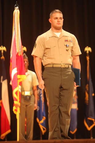 MARINE CORPS BASE CAMP LEJEUNE, N.C. – Sergeant Joshua L . Moore presents his Navy Cross to the audience after being pinned by the Secretary of the Navy, the Honorable Ray Mabus, during an awards ceremony Nov. 1, 2013 aboard Camp Lejeune, N.C.  Moore, 25, from Franklinville, N.C., received the military’s second highest award for his extraordinary heroism while serving as a scout with scout sniper platoon, 2nd Bn., 8th Marines, in support of Operation Enduring Freedom, March 14, 2011. “It’s an honor to receive an award like the Navy Cross,” said Moore. “But to be honest, I was just doing my job.”