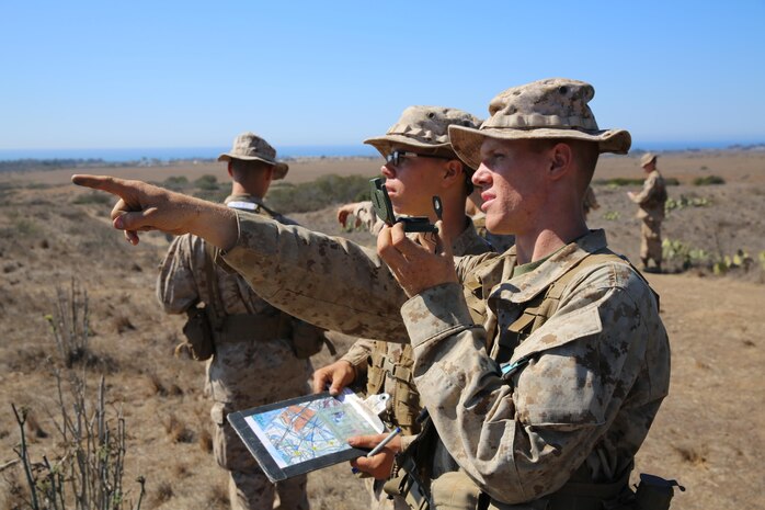 Recruits Guy T. Muches and Benjamin I. Smith (left and right) finds where their next navigation point during the Land  Navigation Course aboard  Marine Corps Base Camp Pendleton, Oct. 15.  Recruits are divided into teams of two for the course.