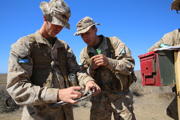 (left to right) Recruits John E. Mercer and Dylan L. Schiltz,  finds their next destination during the Land Navigation Course at Edson Range.  Recruits worked to find five different navigation points along the course using only a compass and a map.