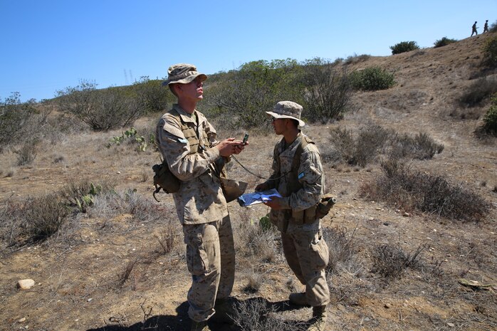 Recruits Minori Mori and John E. Mercer (left to right)double check their data the way to finding their next navigation point. During Land Navigation training recruits are divided into two-man teams.