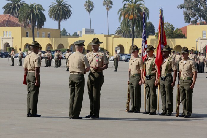 Brig. Gen. James W. Bierman, commnading general, Marine Corps Recruit Depot San Diego and Western Recruiting Region, congratulates Sgt. Maj. Sylvester D. Daniels after presenting him with the  the Legion of Merit (gold star in lieu of second award) during a post and relief ceremony at Marine Corps Recruit Depot San Diego and Western Recruiting, Oct. 25.  Daniels retires after 31 years of service. 