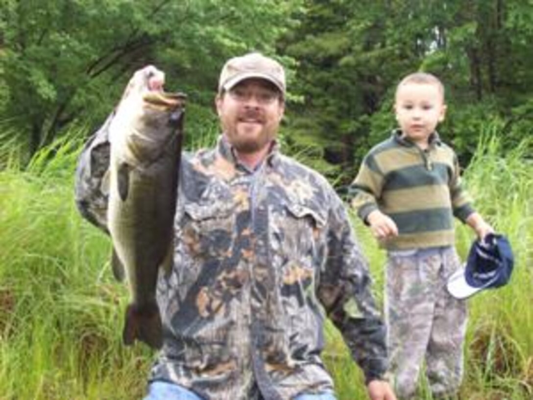 A fisherman holds up a fish caught at Birch Hill Dam, Royalston, Mass. (U.S. Army Corps of Engineers photo)