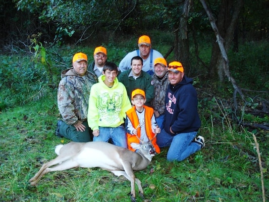 Spencer Deckard, center, holds the horns of the six-point buck he harvested during a special hunt Oct. 20. His brother is beside him. Gathered around him, from left, are Oklahoma Department of Wildlife Conservation Game Warden Jeff Brown, U.S. Army Corps of Engineers Park Rangers Jason Person and Raef Perryman (no hat), John Wiest, Rob Mills, and Mike Deckard. 