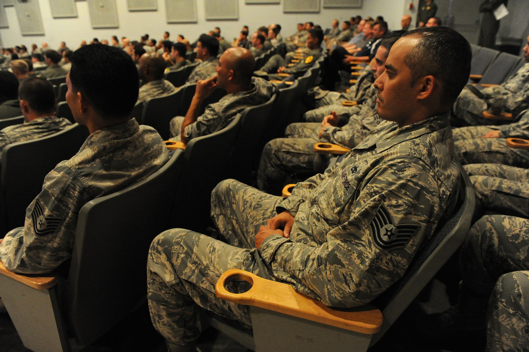 Members of the active duty 15th Wing and 154th Wing of the Hawaii Air National Guard Wing listen attentively during their Consolidated Unit Inspection Right Start Briefing at the Memorial Theater, Joint Base Pearl Harbor-Hickam, Hawaii, Oct. 31. The Airmen will exercise their ability to perform as a cohesive Total Force Integration unit by working side-by-side to accomplish the mission during next week’s Operational Readiness Inspection. (U.S. Air Force photo/Tech. Sgt. Jerome Tayborn)