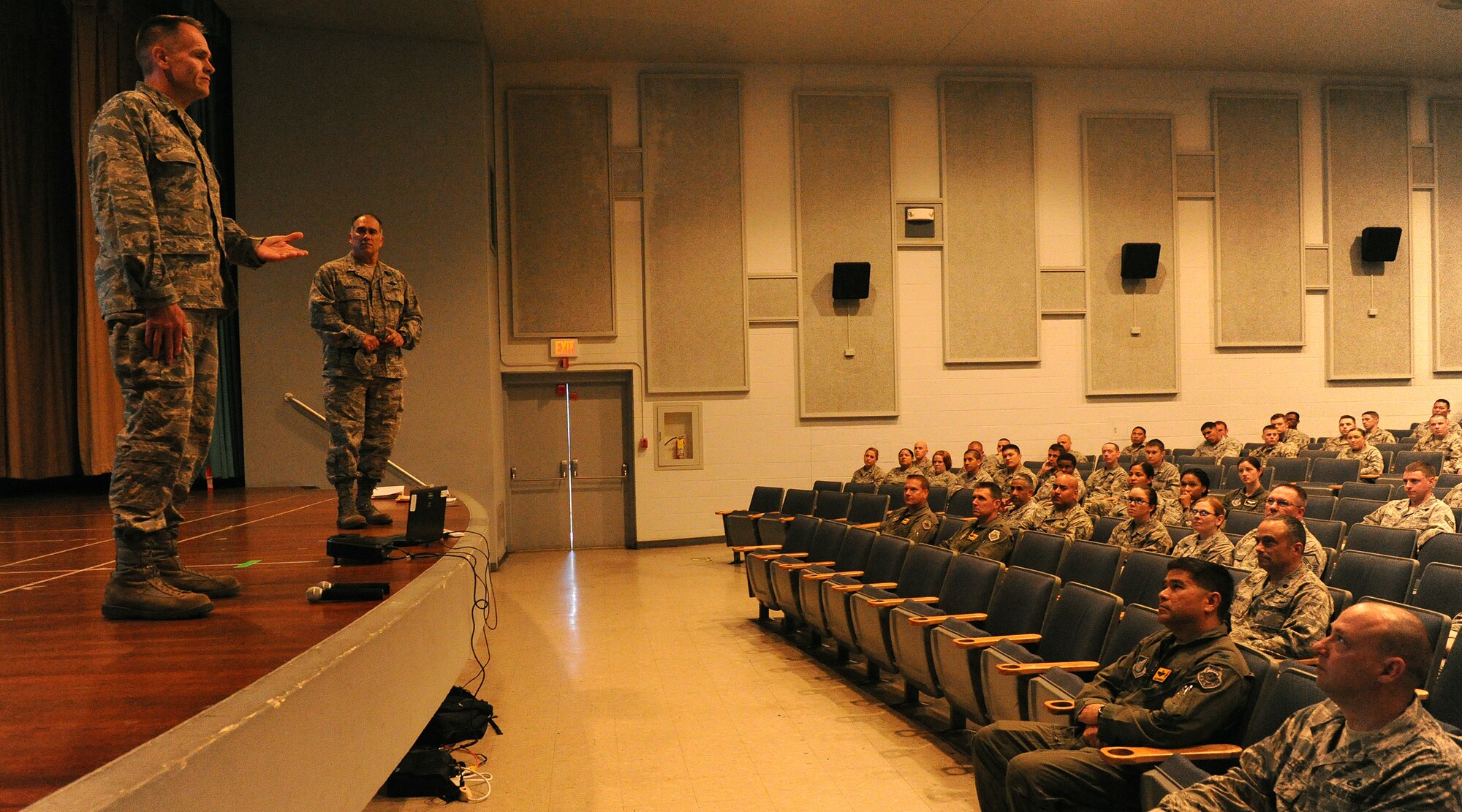 Col. Johnny Roscoe, 15th Wing commander, left, and Brig. Gen. Braden Sakai, 154th Wing commander Hawaii Air National Guard, right, address the men and women of the 15th WG and 154th Wing during the Consolidated Unit Inspection Right Start Brief at the Memorial Theater, Joint Base Pearl Harbor-Hickam, Hawaii, Oct. 31.  Roscoe and Braden briefed their personnel on the importance of working together as one team to accomplish the mission. (U.S. Air Force photo/Tech. Sgt. Jerome Tayborn)