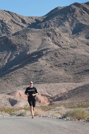 Master Sgt. Luke McCarthy, 99th Security Forces Squadron Charlie One flight chief, runs down a back road located in Area 2 during a training workout Oct. 31, 2013, at Nellis Air Force Base, Nev. McCarthy trains five days a week for three to five miles during each session and supports Life of a Warrior initiative warrior trained fitness work outs as a fitness cadre. The Life of a Warrior initiative challenges Airmen to grow in the physical, mental, social and spiritual areas of their lives and to invest in positive growth rather than a destructive lifestyle. (U.S. Air Force photo by Staff Sgt. Christopher Hubenthal)  