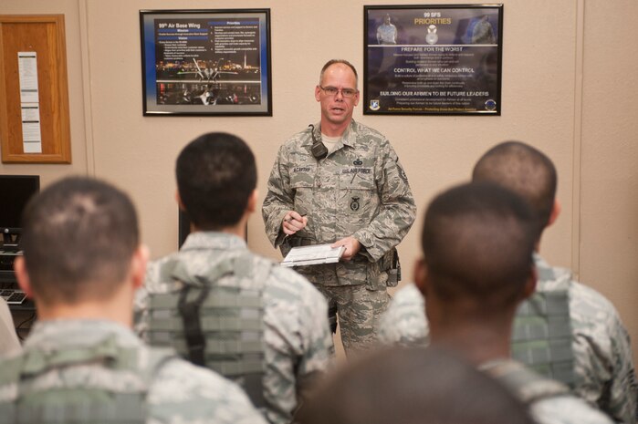Master Sgt. Luke McCarthy, 99th Security Forces Squadron Charlie One flight chief, briefs SFS Airmen during guard mount at the beginning of his flight’s shift Oct. 20, 2013, at Nellis Air Force Base, Nev. McCarthy supports Life of a Warrior initiative driven events for Nellis and Creech AFBs and distinguishes himself in his personal physical fitness, accomplishing multiple half marathons and 50 mile runs. The Life of a Warrior initiative challenges Airmen to grow in the physical, mental, social and spiritual areas of their lives and to invest in positive growth rather than a destructive lifestyle. (U.S. Air Force photo by Staff Sgt. Christopher Hubenthal)