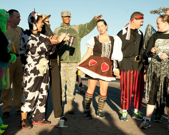 Runners participate in a costume contest as part of the Halloween 5 kilometer run at the Warrior Fitness Center Oct. 31, 2013, at Nellis Air Force Base, Nev. The best costume was judged by how much noise and enthusiasm the audience produced when each contestant was introduced. (U.S. Air Force photo by Airman 1st Class Timothy Young)