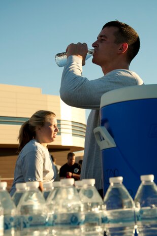 An Airman takes a drink of water after completing the Halloween 5 kilometer run at the Warrior Fitness Center Oct. 31, 2013, at Nellis Air Force Base, Nev. Runners were able to dress in costumes, win prizes and compete in a best costume competition. (U.S. Air Force photo by Airman 1st Class Timothy Young)