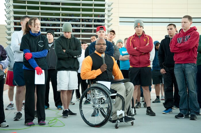 Reggie Bennett, Rebuilding All Goals Efficiently executive director, thanks armed forces members and wounded warriors for their service in support of National Disability Employment Awareness Month during the Halloween 5 kilometer run at the Warrior Fitness Center Oct. 31, 2013, at Nellis Air Force Base, Nev. National Disability Employment Awareness Month is aimed at educating that those with disabilities are equal in accomplishing life's tasks. (U.S. Air Force photo by Airman 1st Class Timothy Young)