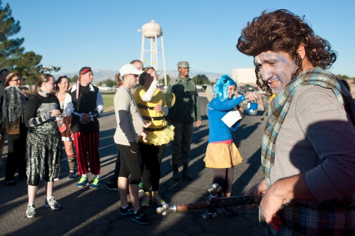 Wesley Morgan, 99th Air Base Wing executive officer, participates in a costume contest as part of the Halloween 5 kilometer run outside the Warrior Fitness Center Oct. 31, 2013, at Nellis Air Force Base, Nev. The best costume was judged by how much noise and enthusiasm the audience produced when each contestant was introduced. (U.S. Air Force photo by Staff Sgt. Christopher Hubenthal)