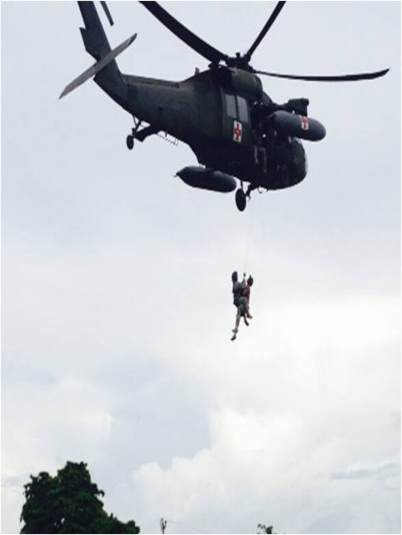 U.S. Army Capt. Christopher Morisoli and Warrrant Officer Dylan Kovenz, both pilots assigned to the 1-228th Aviation Regiment, Joint Task Force-Bravo, hold a HH-60 Blackhawk helicopter at a high hover while U.S. Army Staff Sgt. Matthew Reed, flight medic, is hoisted up by U.S. Army Staff Sgt. Kyle Farnes during a live hoist training exercise in Puerto Castilla, Honduras, Oct. 30, 2013.  The 1-228th's "C" Company teamed up with Special Boat Team 22 as well as Honduran soliders to conduct the training.  (Photo by U.S. Army 1st Lt. Michael Pierce)