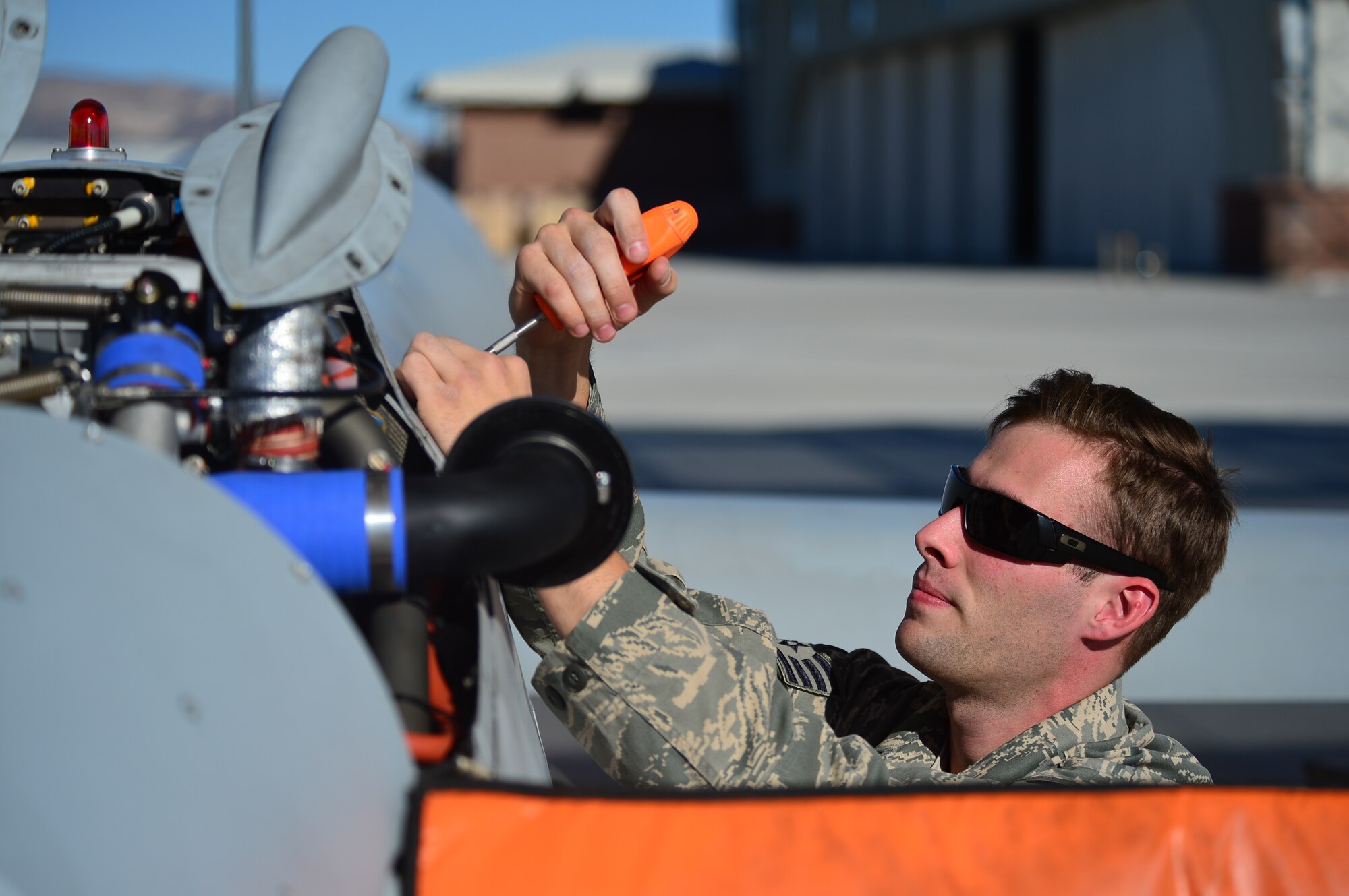 LAS VEGAS, Nev -- A crew chief from the 432nd Aircraft Maintenance Squadron de-panels an MQ-1 Predator remotely piloted aircraft during a post-flight inspection Nov. 1, 2013. Predators can perform the following missions and tasks: intelligence, surveillance, reconnaissance, close air support, combat search and rescue, precision strike, buddy-lase, convoy/raid overwatch, route clearance, target development, and terminal air guidance. The USAF’s MQ-9 Reaper and MQ-1 Predator fleet surpassed 2 million cumulative flight hours on Oct. 22, 2013. (U.S. Air Force photo by Staff Sgt. N.B./released)