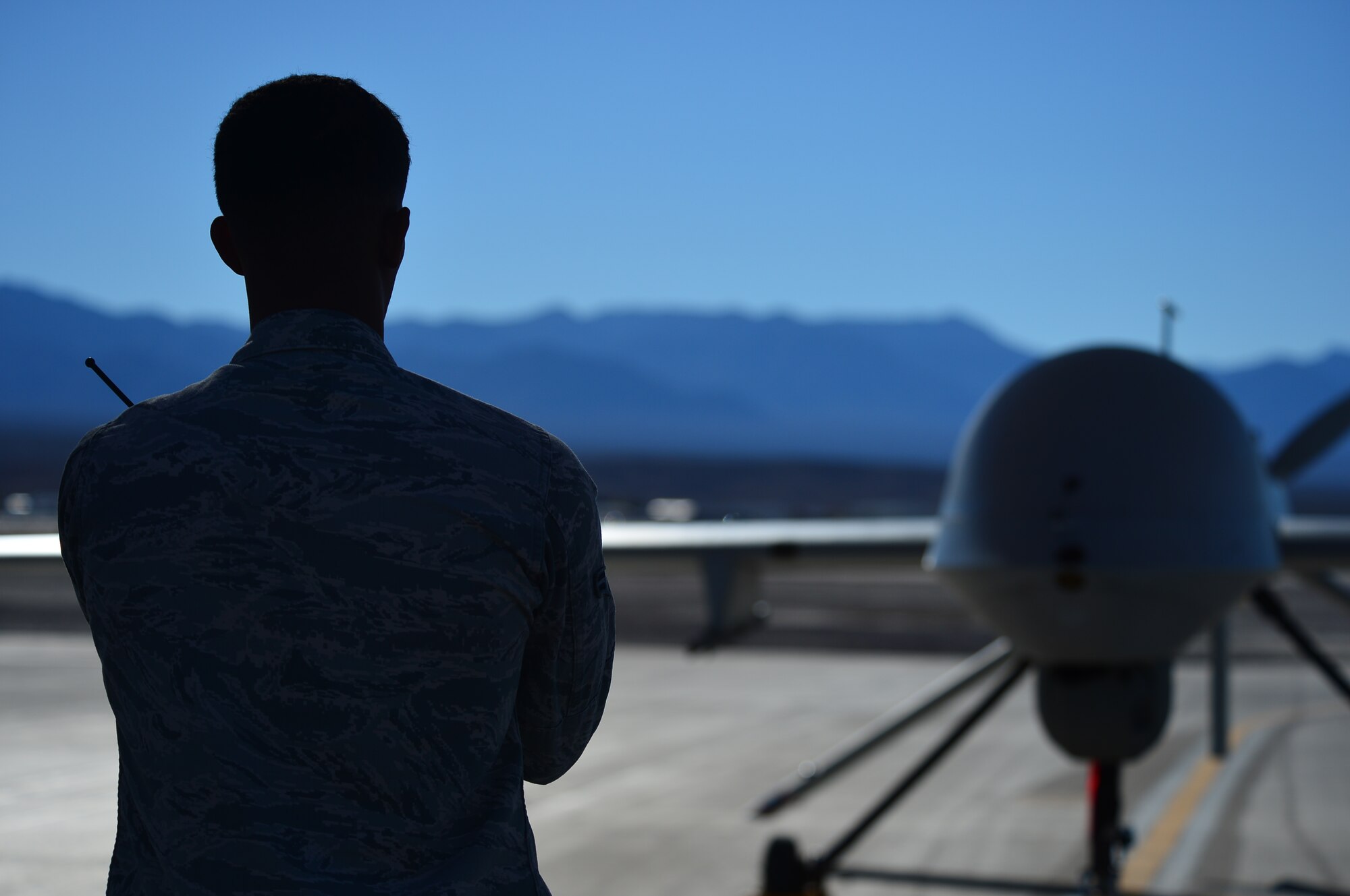 LAS VEGAS, Nev -- A crew chief from the 432nd Aircraft Maintenance Squadron taxis in an MQ-1 Predator remotely piloted aircraft during a post-flight inspection Nov. 1, 2013. The MQ-1 Predator is an armed, multi-mission, medium-altitude, long-endurance RPA that is employed primarily as an intelligence-collection asset and secondarily against dynamic execution targets. The USAF’s MQ-9 Reaper and MQ-1 Predator fleet surpassed 2 million cumulative flight hours on Oct. 22, 2013. (U.S. Air Force photo by Staff Sgt. N.B./released)