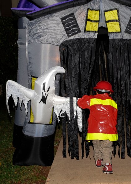 A child walks through a haunted house on Barksdale Air Force Base, La., Oct. 31, 2013. The base housing areas were open to Barksdale Airmen and their families for trick-or-treating from 5:30 p.m. to 8:00 p.m. (U.S. Air Force photo/Senior Airman Kristin High)