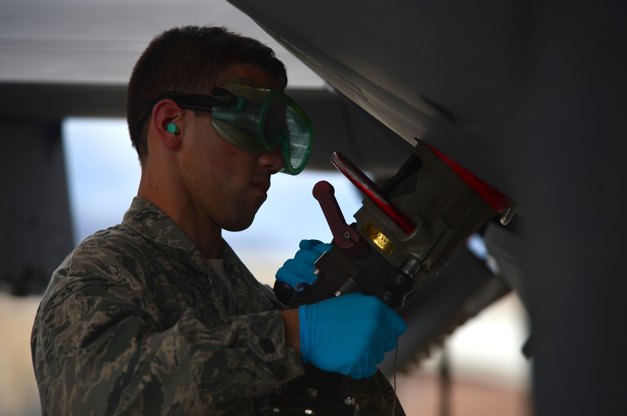 LAS VEGAS, Nev. -- A 432nd Aircraft Maintenance Squadron maintainer latches a fuel line onto remotely piloted aircraft during a post-flight inspection Oct. 28, 2013. The U.S. Air Force's MQ-1 Predator and MQ-9 Reaper remotely piloted aircraft fleet surpassed 2 million total flight hours on Oct. 22, 2013.  Remotely piloted aircraft fly in support of overseas contingency operations and humanitarian aid. (U.S. Air Force photo by Staff Sgt. N.B./released)
