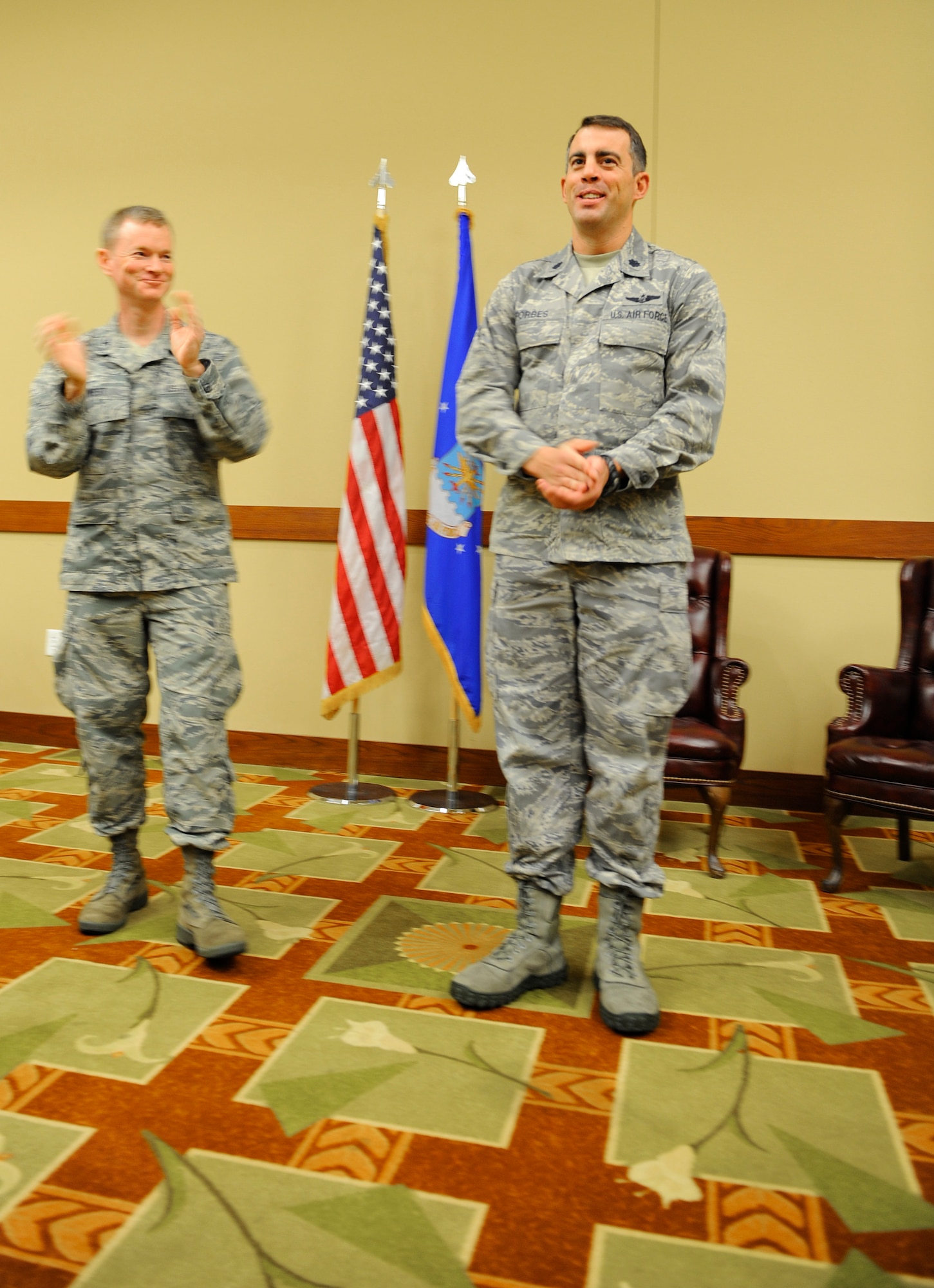 Col. William West, 1st Special Operations Wing commander, applauds Lt. Col. Phil Forbes, 1st Special Operations Air Operations Squadron commander, after Forbes assumed command of the 1st SOAOS at the Soundside Club on Hurlburt Field, Fla., Nov. 1, 2013. The squadron activated at 11:15 a.m. (U.S. Air Force photo/Airman 1st Class Jeff Parkinson)