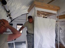 Members of Joint Task Force-Bravo's Army Forces Battalion (ARFOR) work on setting up a portion of the Lite Expeditionary Camp system, Oct. 29, 2013.  The Lite Expeditionary Camp system consists of seven total tents, with the capability to house servicemembers and maintain military operations for up to ten years with proper upkeep.  (Photo by U.S. Army Spc. Christopher Floyd)