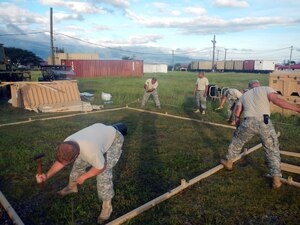 Members of Joint Task Force-Bravo's Army Forces Battalion (ARFOR) work on setting up a portion of the Lite Expeditionary Camp system, Oct. 29, 2013.  The Lite Expeditionary Camp system consists of seven total tents, with the capability to house servicemembers and maintain military operations for up to ten years with proper upkeep.  (Photo by U.S. Army Spc. Christopher Floyd)